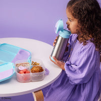 Child drinking from a BBox Frozen Insulated Drink Bottle with a purple table and the BBox Frozen lunchbox 