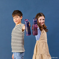 Two children holding BBox Harry Potter water bottles against a blue background