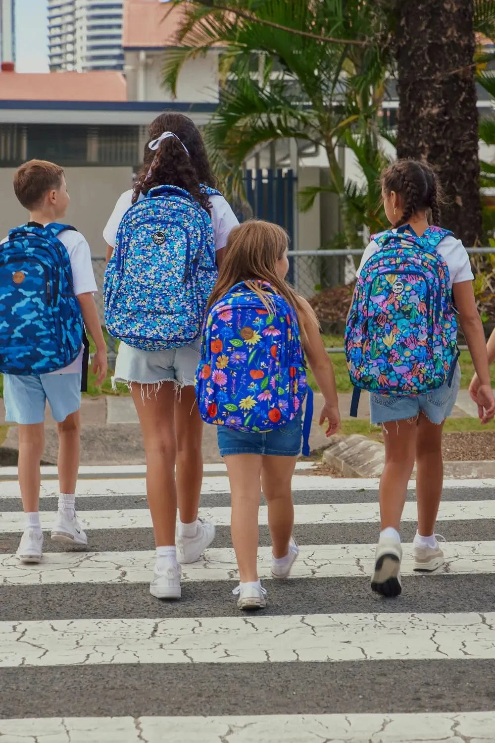 Group of school children walking to school wearing Alimasy School Backpacks