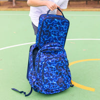 A child putting a Montii High Voltage Large Insulated Lunch Bag into a matching school backpack.