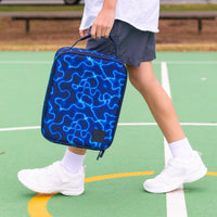 A child walking on a green outdoor court carrying a Montii High Voltage Large Insulated School Lunch Bag