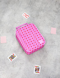 The Queen of Hearts Montii Large Insulated Lunchbag, styled on a gray concrete floor with playing cards..