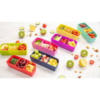 Montii Feast Bento Tray filled with various fruits and snacks on a light surface.