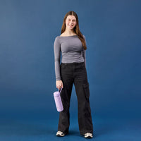 Woman holding a Lilac Love BBox Insulated Drink bottle against a blue background
