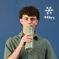 Person holding an Olive BBox insulated bottle with a blue background and snowflake icon displaying '44 hrs', showing it can keep drink cold for 44 hours!