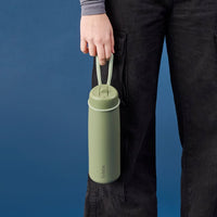 Person holding a Olive BBox water bottle with a blue background