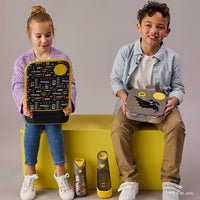 Two children holding BBox Batman-themed lunch boxes on a gray background