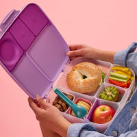 Child holding the Sugar Plum BBox Lunchbox filled with lunch foods