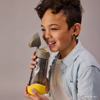 Child drinking from a BBox Batman 600ml Tritan Drink Bottle against a plain background