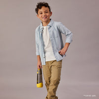 Child wearing a light blue shirt and beige pants holding a BBox Batman 
water bottle against a gray background