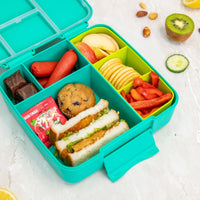 Colorful Montii Feast Lunchbox  filled with various food items on a light background