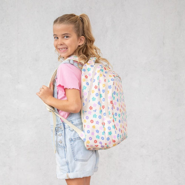 Girl with the Montii Daisy Dream Junior backpack on a plain background